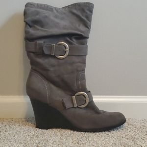 Gray mid height boots w/ buckle accents.